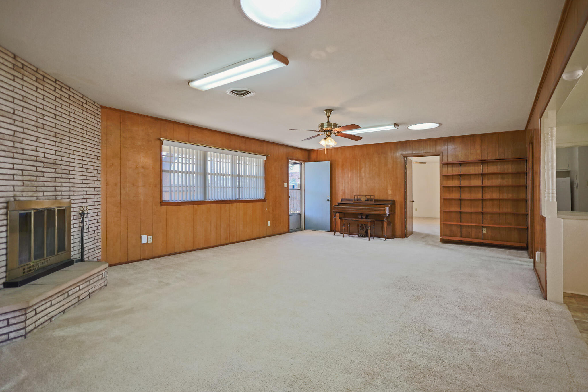 5517 26th Street Lubbock, TX 79407 - Photo 9 of 55 a view of a livingroom with furniture and a ceiling fan