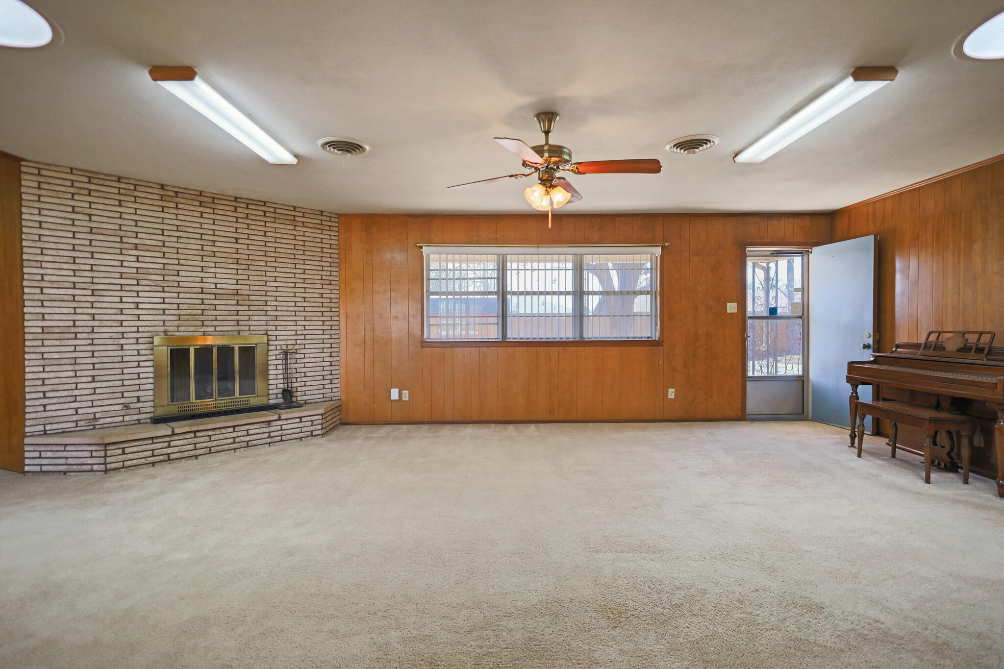 5517 26th Street Lubbock, TX 79407 - Photo 10 of 55 a view of empty room with a fireplace and fan