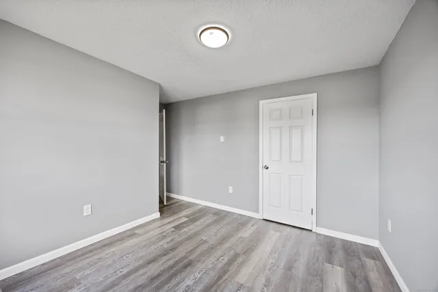 a view of an empty room and wooden floor