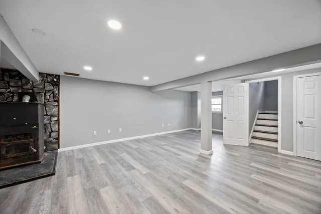 a view of wooden floor and windows in a room