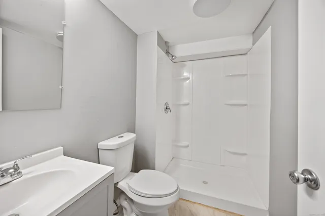 a white toilet sitting next to a bathroom sink