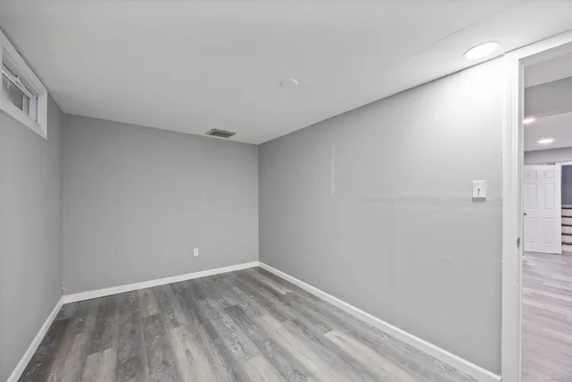 a view of a room with wooden floor