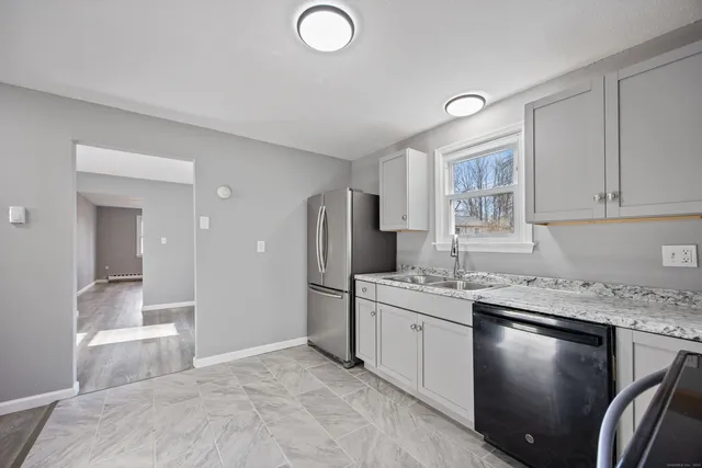 a kitchen with a sink stove and cabinets