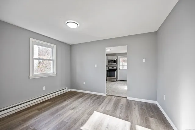 wooden floor in an empty room with a window