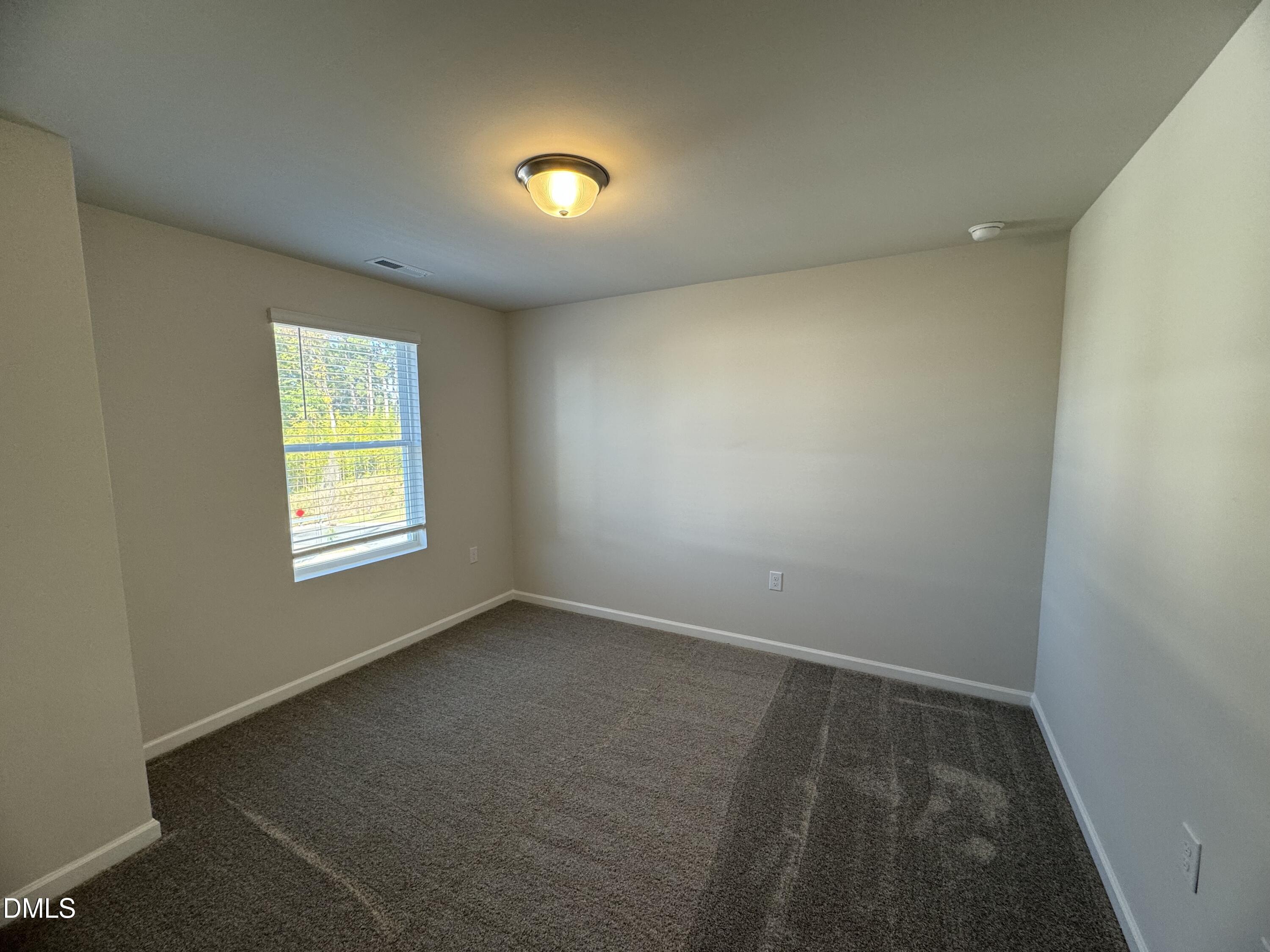 442 Sustainable Way Raleigh, NC 27610 - Photo 11 of 12 an empty room with a window