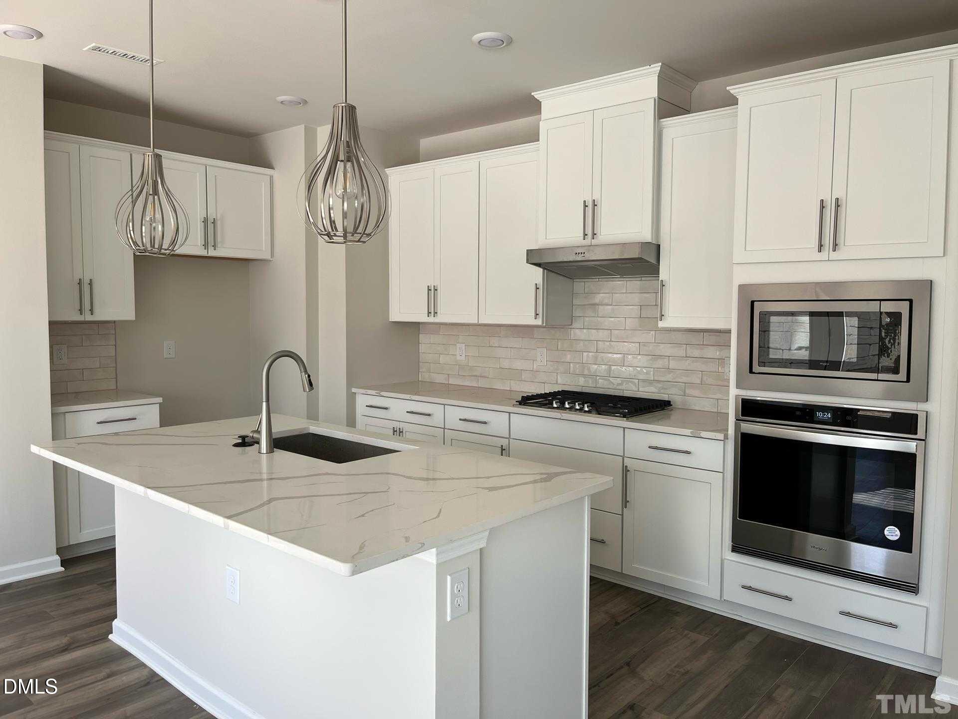 442 Sustainable Way Raleigh, NC 27610 - Photo 3 of 12 a kitchen with stainless steel appliances granite countertop a sink a stove and a granite counter tops