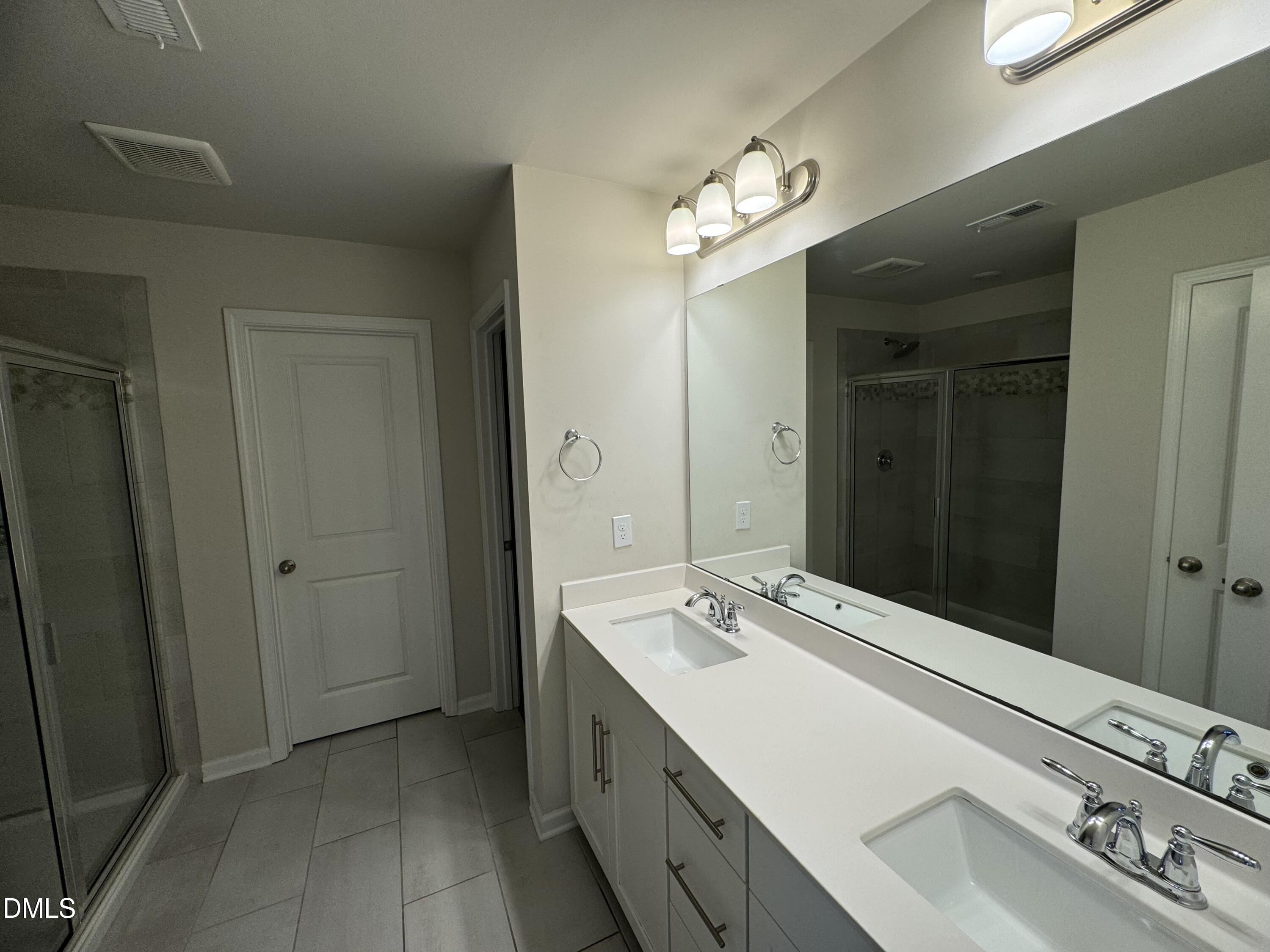 442 Sustainable Way Raleigh, NC 27610 - Photo 7 of 12 a bathroom with a sink double vanity and a mirror