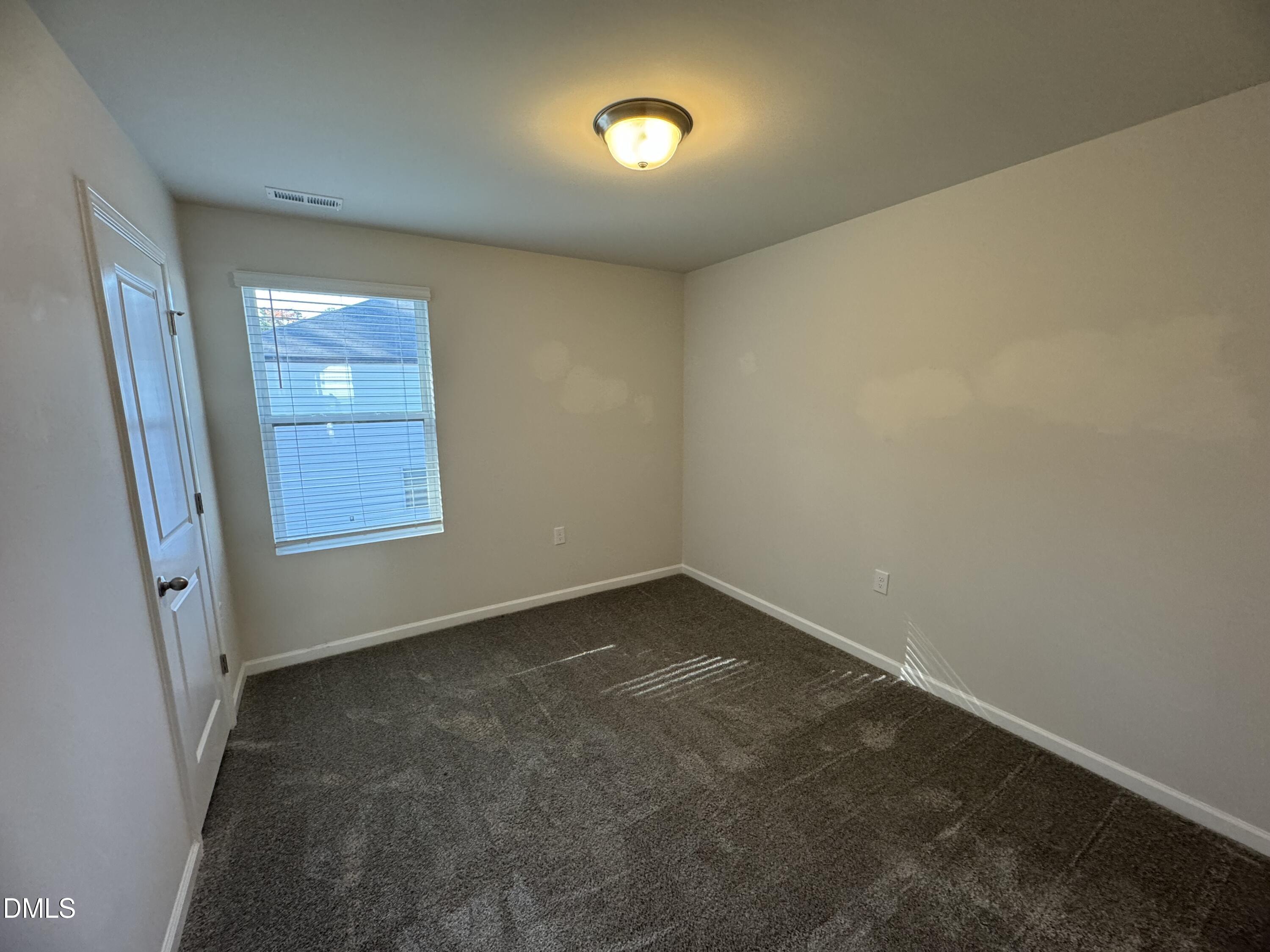 442 Sustainable Way Raleigh, NC 27610 - Photo 9 of 12 an empty room with a window