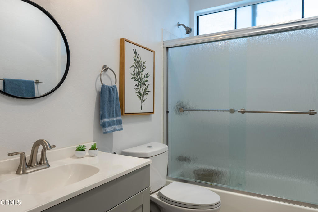 12007 Rochester Avenue, Unit 1 Los Angeles, CA 90025 - Photo 13 of 32 a bathroom with a sink toilet and a mirror