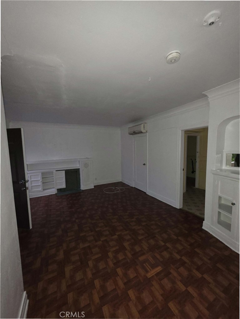 111 North Soto Street Los Angeles, CA 90033 - Photo 2 of 10 a bedroom with a bed and a fireplace