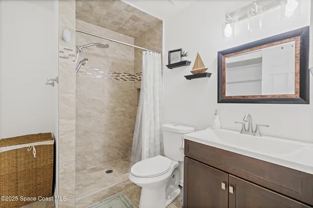 a bathroom with a sink mirror vanity and toilet