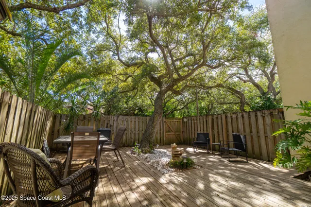 a view of house with backyard and sitting area
