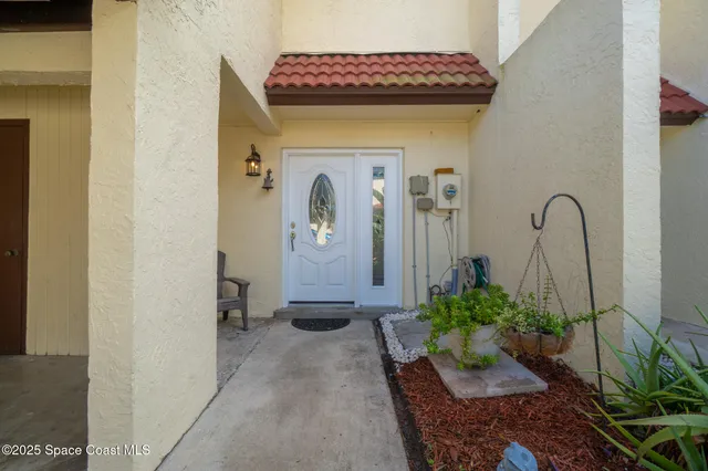 an aerial view of a city with lots of residential buildings ocean and mountain view in back