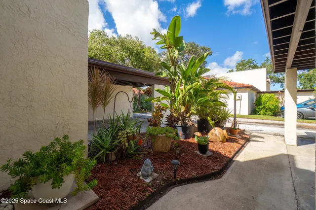 a view of staircase with wooden floor and white walls