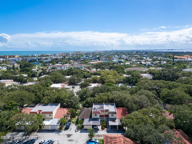 a view of hallway with stairs and wooden floor