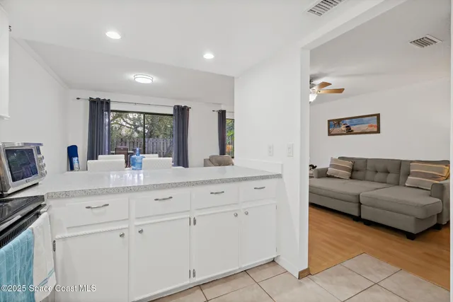 a dining room with furniture and a floor to ceiling window