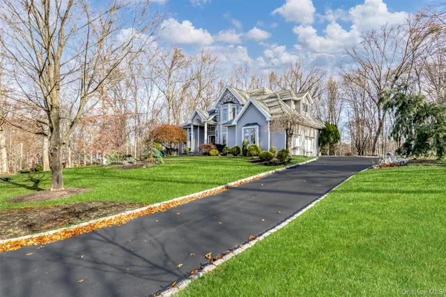 a front view of house with yard and green space