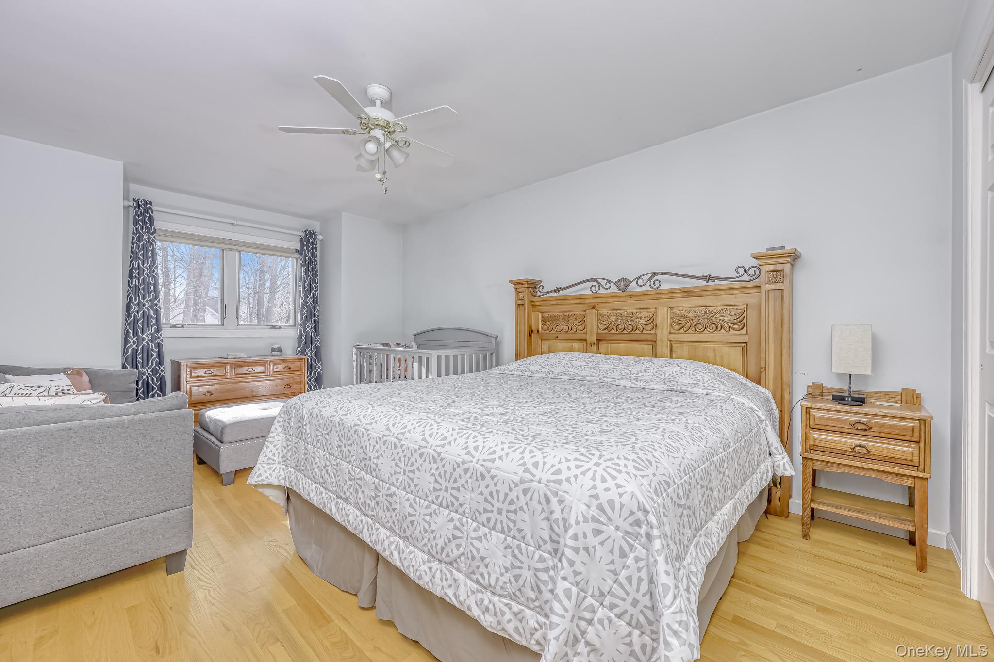 6 Wedge Way Suffern, NY 10901 - Photo 15 of 27 a bedroom with a bed and a chandelier