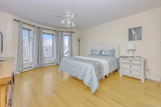 a spacious bedroom with a bed and a chandelier