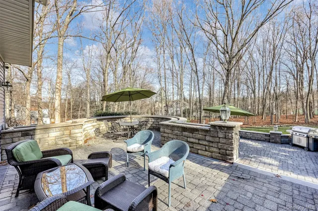 a view of a patio with couches table and chairs and potted plants