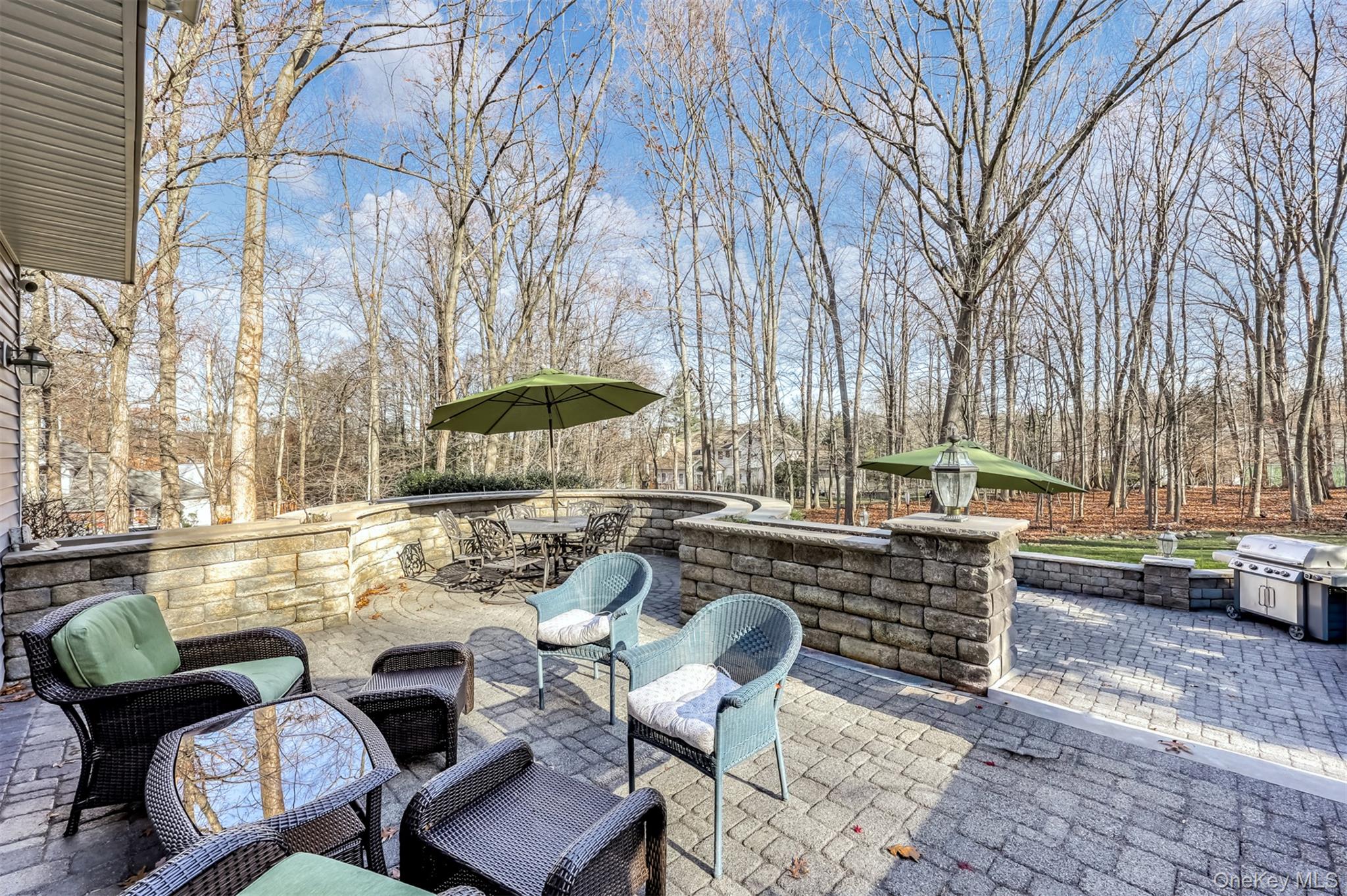6 Wedge Way Suffern, NY 10901 - Photo 22 of 27 a view of a patio with couches table and chairs and potted plants