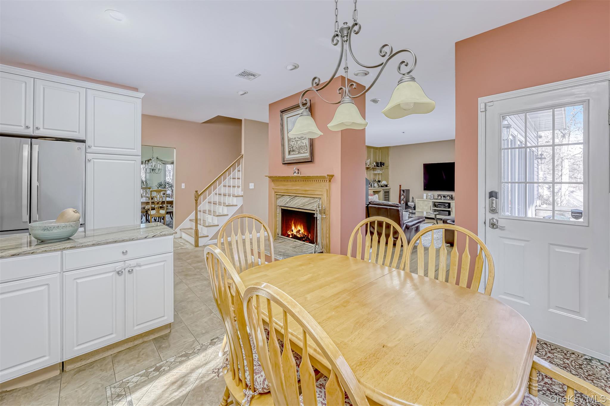 6 Wedge Way Suffern, NY 10901 - Photo 7 of 27 a kitchen with stainless steel appliances kitchen island granite countertop a stove a sink a dining table and chairs with wooden floor