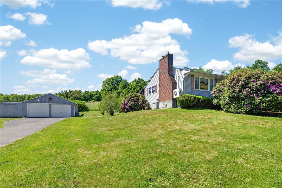 62 Stoney Road Tamaqua, PA 18252 - Photo 47 of 61 A verdant hillside offers a secluded setting for this home, featuring a detached garage and brick chimney.