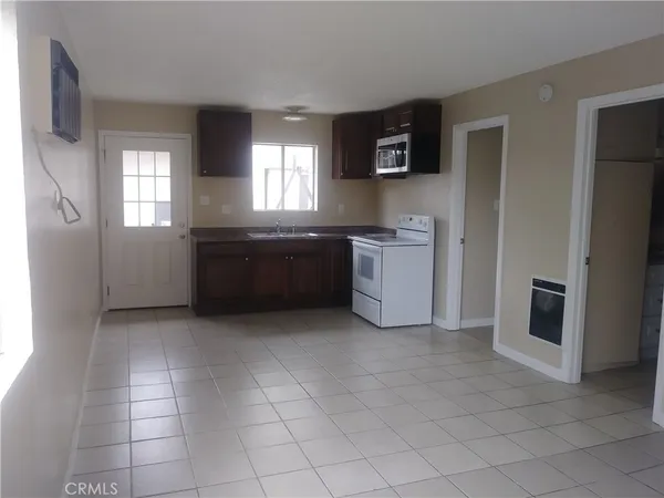 a large kitchen with a stove a sink and a refrigerator