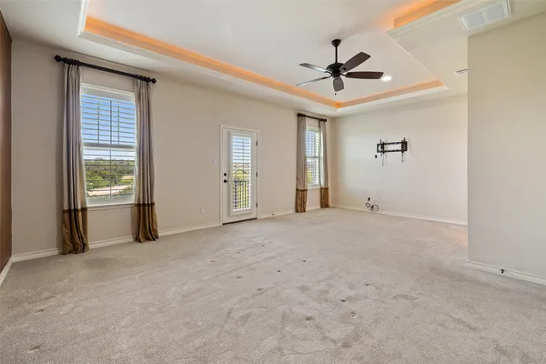 a view of a livingroom with a ceiling fan and window