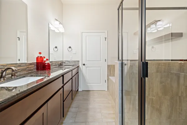 a spacious bathroom with a double vanity sink mirror and double