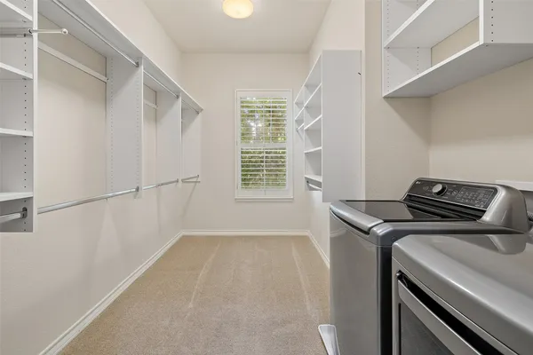 a view of storage and utility room with washer and dryer