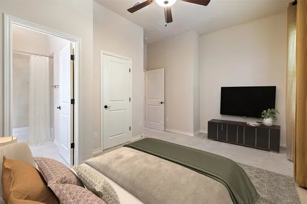 a bedroom with a bed and a flat screen tv