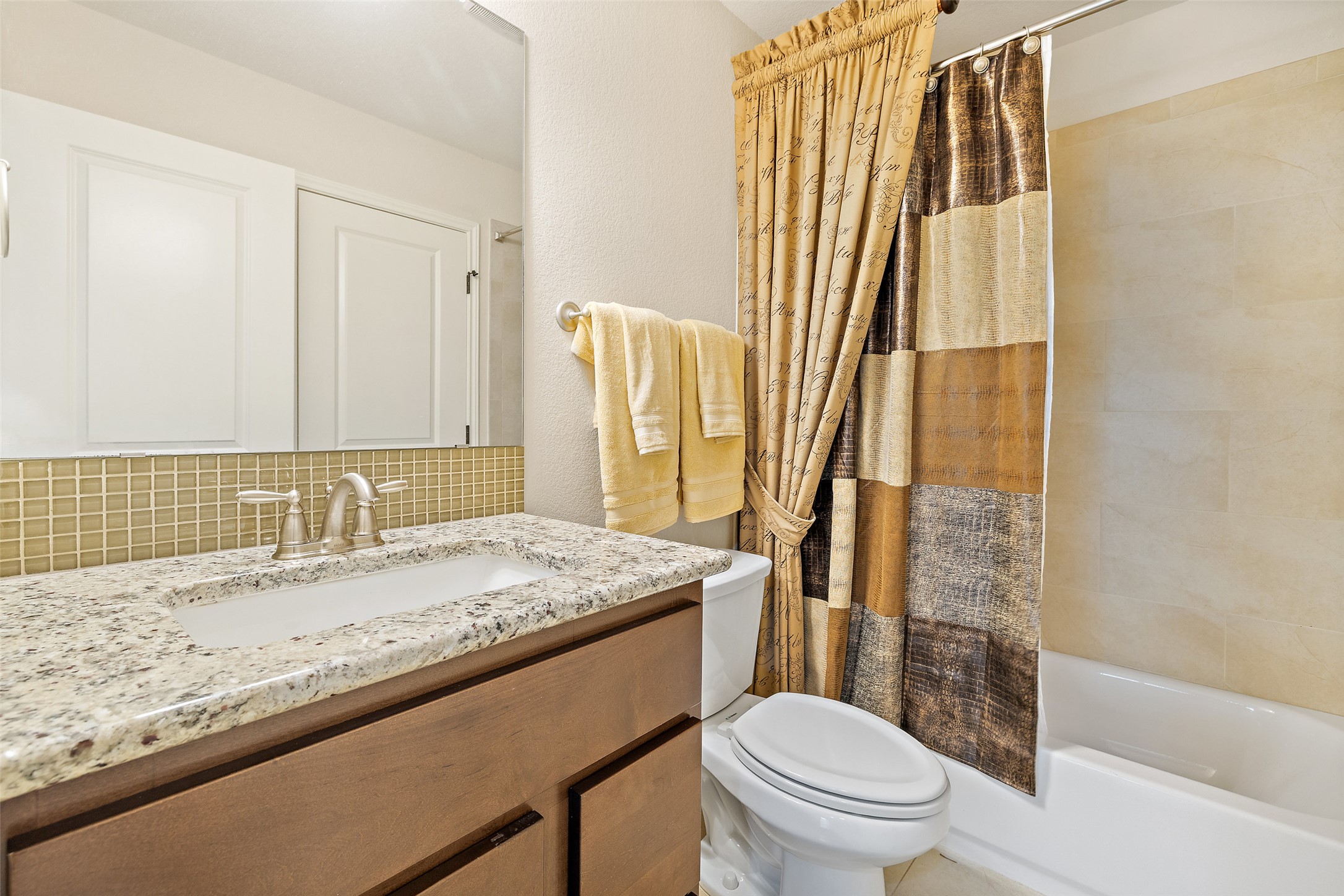233 Adams Street Georgetown, TX 78628 - Photo 22 of 37 a bathroom with a granite countertop sink and a mirror