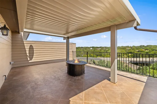 a view of a patio with a table and chairs and floor to ceiling window