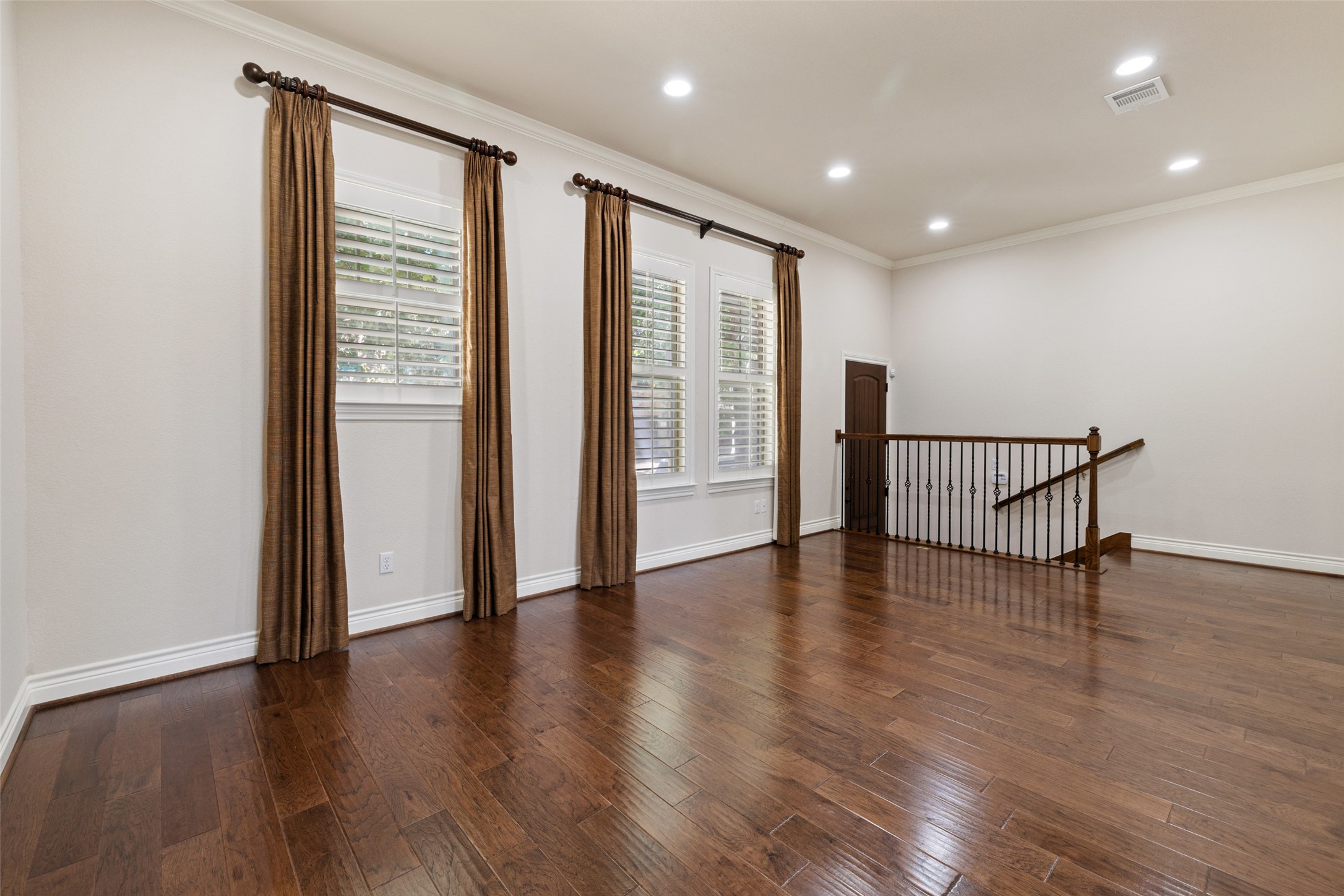 233 Adams Street Georgetown, TX 78628 - Photo 4 of 37 a view of an empty room with wooden floor and a window