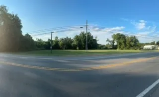 a backyard of a house with lots of green space and outdoor seating