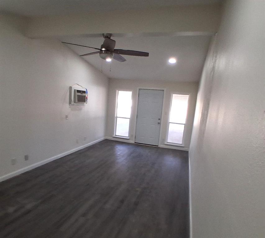 516 Forrest Lane Denison, TX 75021 - Photo 3 of 16 an empty room with wooden floor and windows