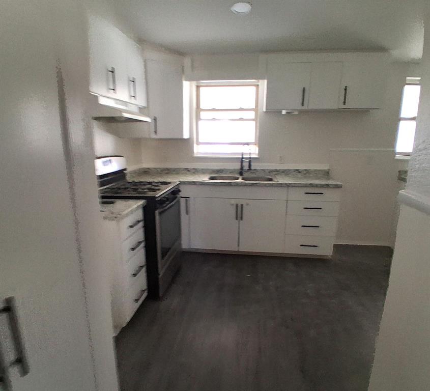 516 Forrest Lane Denison, TX 75021 - Photo 5 of 16 a kitchen with stainless steel appliances granite countertop a sink a stove a refrigerator and white cabinets
