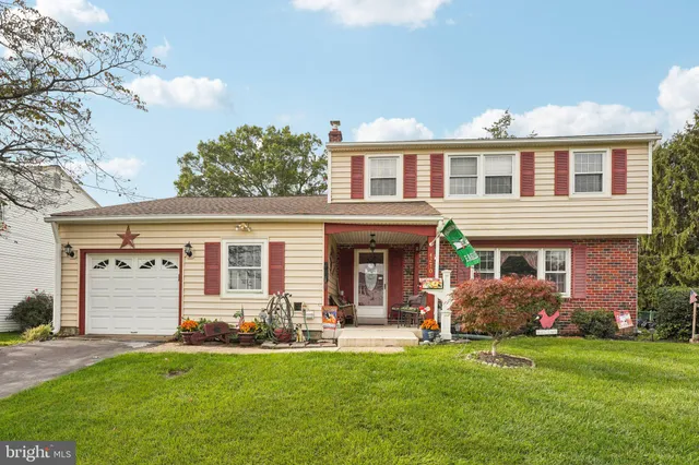a front view of house with yard and outdoor seating