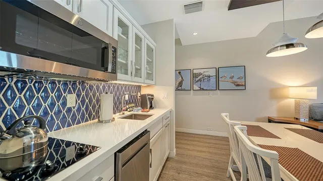 a kitchen with a sink and a stove top oven