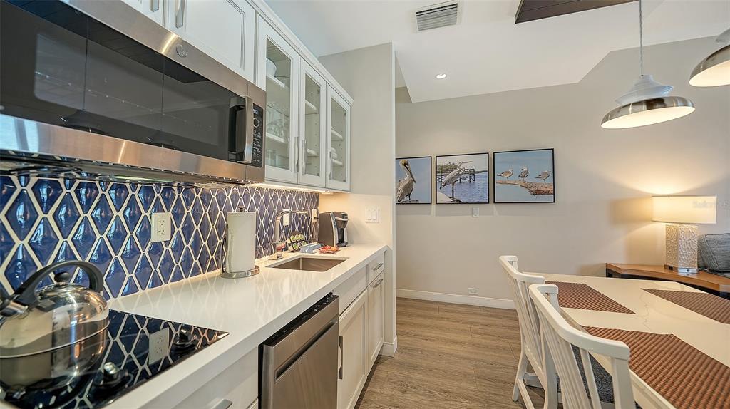 225 Sands Point Road, Unit 6201 Longboat Key, FL 34228 - Photo 14 of 30 a kitchen with a sink and a stove top oven