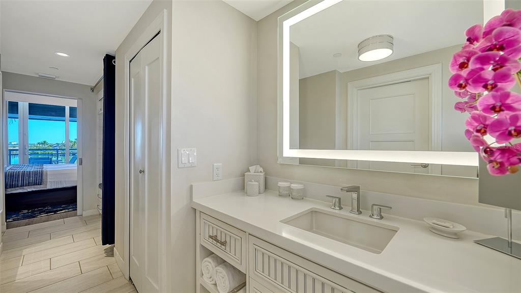 225 Sands Point Road, Unit 6201 Longboat Key, FL 34228 - Photo 18 of 30 a bathroom with a sink and a mirror