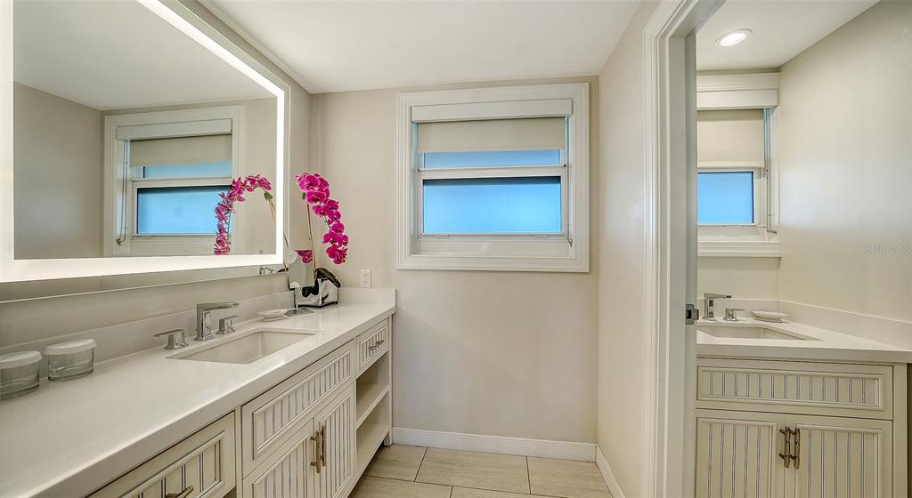 225 Sands Point Road, Unit 6201 Longboat Key, FL 34228 - Photo 19 of 30 a bathroom with a sink and a mirror