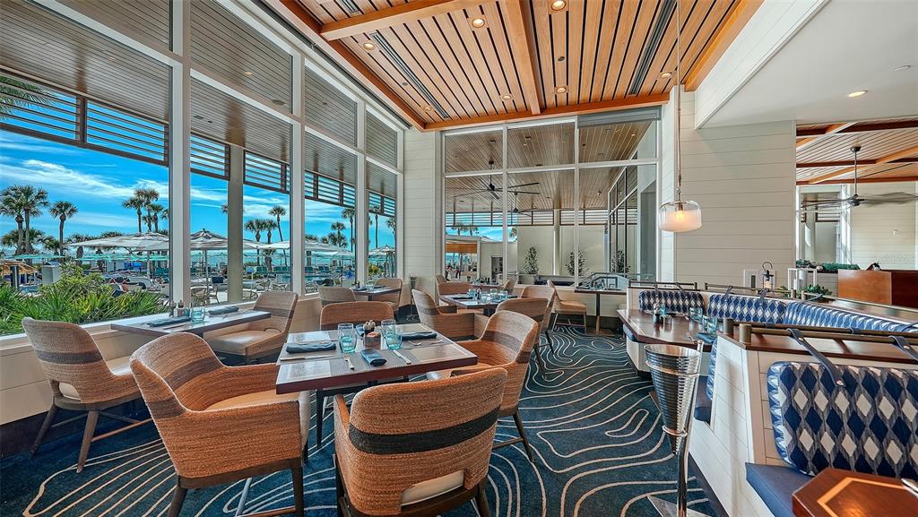 225 Sands Point Road, Unit 6201 Longboat Key, FL 34228 - Photo 23 of 30 a view of a patio with couches chairs dining table and chairs