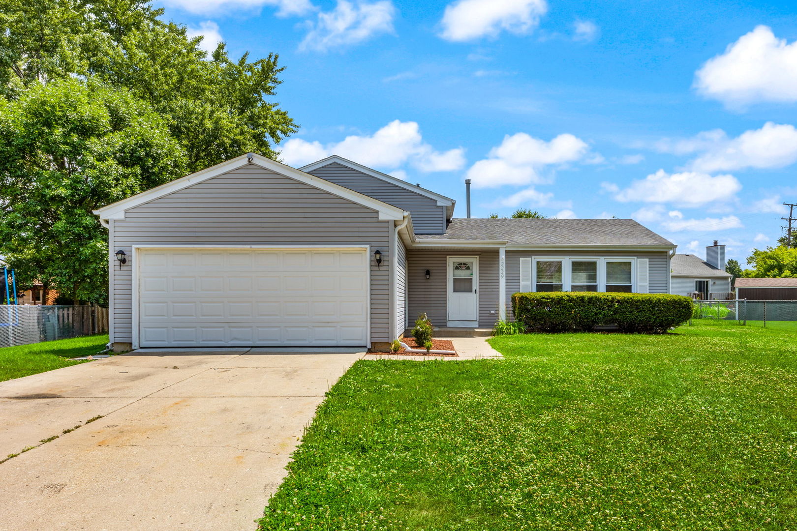 2229 Kensington Drive Schaumburg, IL 60169 - Photo 1 of 14 a front view of a house with a yard and garage
