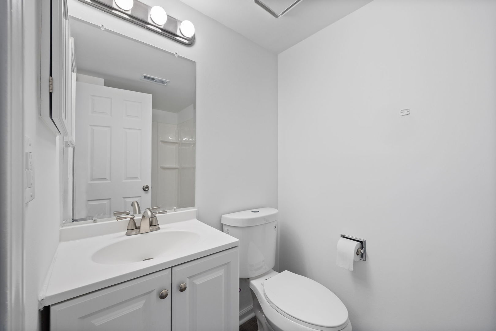 2229 Kensington Drive Schaumburg, IL 60169 - Photo 11 of 14 a bathroom with a sink a toilet and a mirror