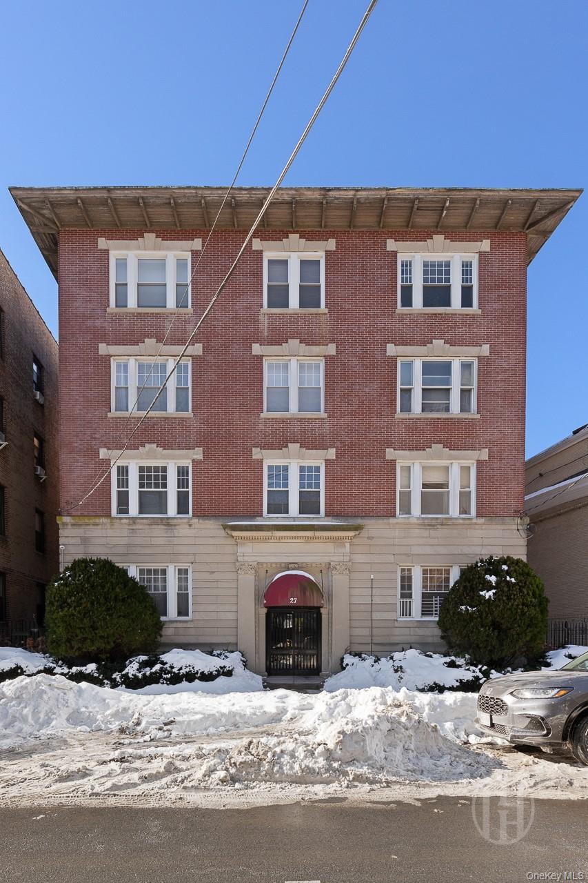 27 Locust Avenue, Unit 2S New Rochelle, NY 10801 - Photo 1 of 1 a front view of a building with yard