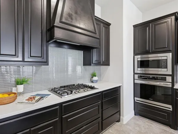 a kitchen with stainless steel appliances a stove and a microwave