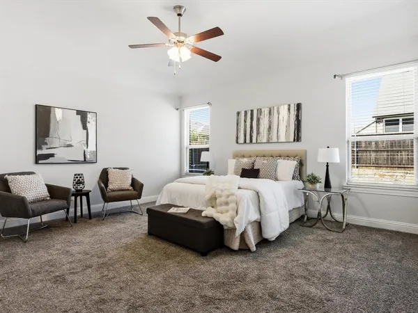 a spacious bedroom with a bed and a large window