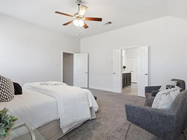 a spacious bedroom with a bed and furniture